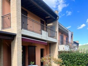 a building with balconies on the side of it at Nice villa with pool and garden in Fermignano