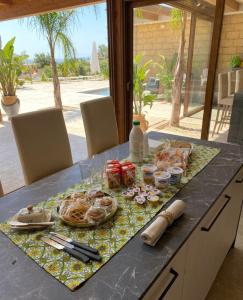 a table with food and drinks on top of it at Le tenute di punta bianca in Agrigento