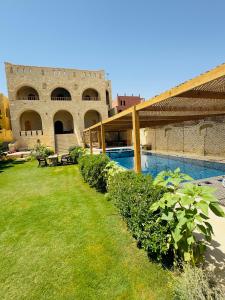 a courtyard of a building with a swimming pool at Pidgeon Lodge - Tunis Village in Tunis