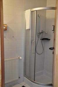 a shower with a glass door in a bathroom at SleepWell24 in Spittal an der Drau