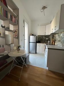 a kitchen with a small table and a refrigerator at SunnyBar in Bar
