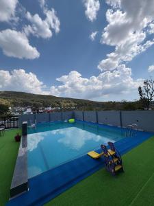 a large swimming pool on the roof of a building at Rivana Retreat in Dehradun