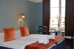 a hotel room with a bed with towels on it at Leopold Boutique Hotel in Östersund