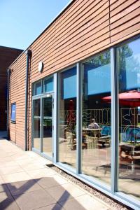 a store front with glass windows with tables and chairs at Riverstone Lodge Hotel in Perth