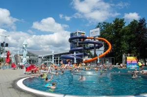 a large swimming pool with a water slide at Apartmány Koliba in Turčianske Teplice