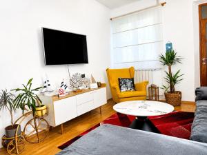 a living room with a couch and a tv on a wall at Holiday Home Lungo Mare in Mlini +69 photos