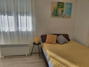 a small bedroom with a bed with a window at HH Klara in Ozalj