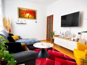 a living room with a couch and a tv at Holiday Home Lungo Mare in Mlini