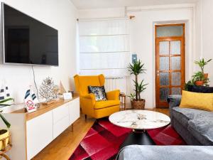 a living room with a couch and a tv at Holiday Home Lungo Mare in Mlini