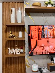 a collage of photos of a room with a bedroom at Nest & Rest Suites Azure North in San Fernando