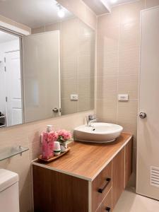 a bathroom with a sink and a mirror at Nest & Rest Suites Azure North in San Fernando +27 photos