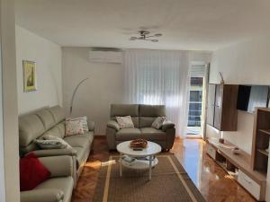 a living room with two couches and a table at HH Klara in Ozalj