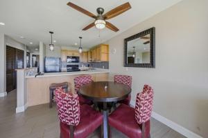 a kitchen and dining room with a table and chairs at Oceanfront Escape Pono Kai Resort A103 in Kapaa