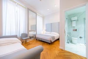 a hotel room with two beds and a shower at Hosianum Palace in Rome +61 photos