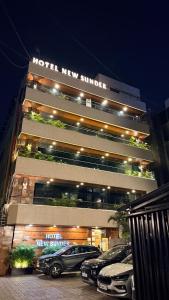 a hotel with cars parked in front of it at Hotel New Sunder in Indore