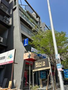 a building with a rocca sign on the side of a street at Hotel Prime Elite in Ahmedabad