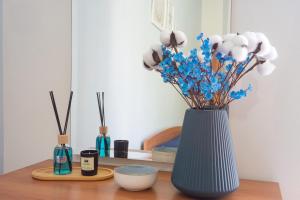 a blue vase with blue flowers sitting on a table at Casa Nel Blu in SantʼAlessio Siculo