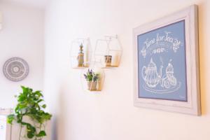 a picture of a sign on a wall with plants at Casa Nel Blu in SantʼAlessio Siculo +17 photos