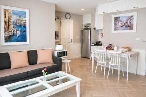 a living room with a couch and a table at The Beach Bangsaen by Thanthita next to Wonnapa beach FREE DISNEY PLUS in Bangsaen