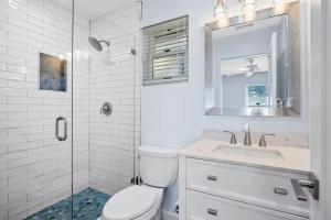 a bathroom with a toilet and a sink and a shower at Pacific Combo WOcean View Private Patio in Ventura +30 photos