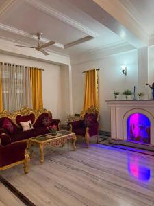 a living room with a couch and a fireplace at H&R Homestay in Guwahati