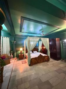 a bedroom with a bed with a canopy at H&R Homestay in Guwahati