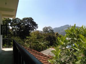 a balcony of a house with a view of a mountain at Mama Cottage Ella in Ella