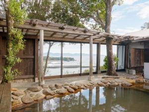 a house with a swimming pool with a view of the water at Yamamizuki in Shimanto