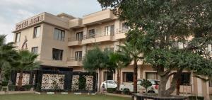 a building with a car parked in front of it at Hotel Asha in Kannauj +8 photos