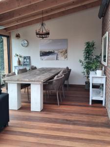 a dining room with a large wooden table and chairs at Slapen & Smullen in Swalmen +16 photos