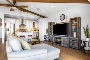 a living room with a white couch and a tv at Pacific Combo WOcean View Private Patio in Ventura