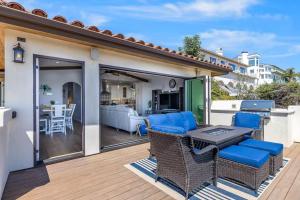 a patio with blue chairs and a table on a deck at Pacific Combo WOcean View Private Patio in Ventura