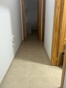 a hallway of a room with a tile floor at APARTAMENTO PALOMAREs in Zújar