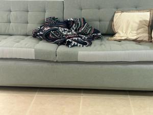 a couch with a blanket on top of it at APARTAMENTO PALOMAREs in Zújar
