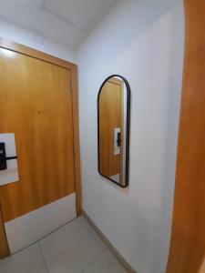 a mirror on a wall next to a door at Casa Mauá 312 in Rio de Janeiro