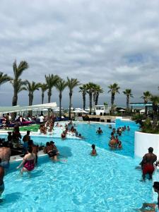 a group of people in a swimming pool at Riviera Hotel and Beach Lounge, Beirut in Beirut