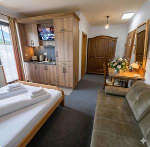 a bedroom with a bed and a table and a couch at Terano Urban Lodge in Maribor in Maribor