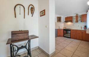 a kitchen with a table in the middle of a room at Stunning Home In Peruski in Peruški