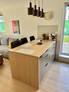 a kitchen with a large island in a living room at Stylish Chill Garden Apartment in Bratislava