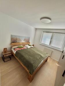 a bedroom with a bed and two windows at Stylish Chill Garden Apartment in Bratislava