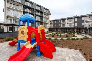 a playground in front of a apartment building at Five seasons Family in Odesa