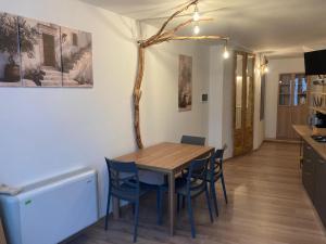 a kitchen and dining room with a wooden table and chairs at Mamma Adelina in Enna