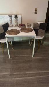 a white table and two chairs in a room at Elis studio luxury apartment in Ierapetra