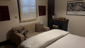 a bedroom with a bed and a chair and a window at Elis studio luxury apartment in Ierapetra