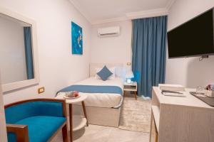 a hotel room with a bed and a tv at pyramids View Top in Cairo