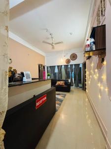 a lobby with a reception counter and a couch at The Pinnacle Stays in Guwahati