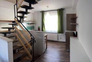 a room with stairs and a kitchen with a window at Casetta Accogliente in San Pietro Avellana