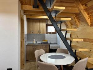 a kitchen and dining room with a table and chairs at Masha in Žabljak