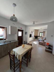 a kitchen and living room with a table and chairs at Athanasia's Eremion in Zagora +12 photos