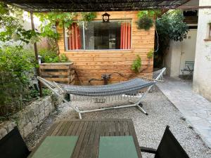 a hammock in front of a wooden cabin at La Casetta in Gattières